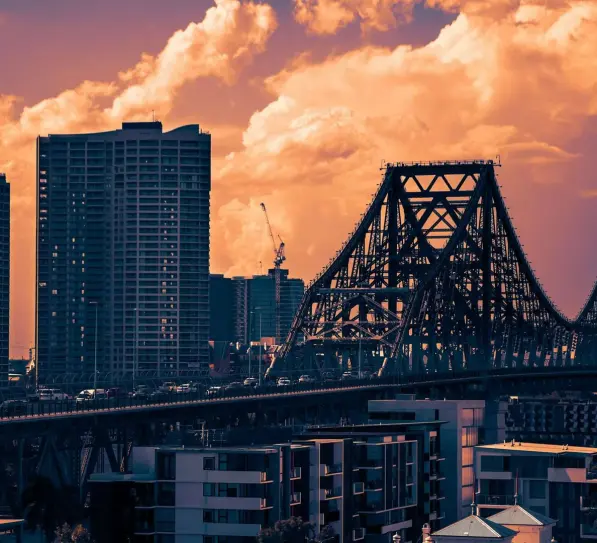 Apartment buildings and the Story Bridge at sunset in Brisbane
